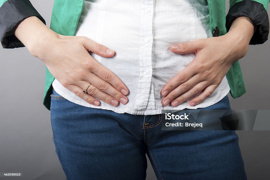 Businesswoman with abdominal pains an image of Businesswoman with abdominal pains Abdomen Stock Photo