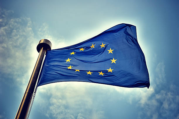 European Union flag European Union flag on blue sky background european parliament stock pictures, royalty-free photos & images