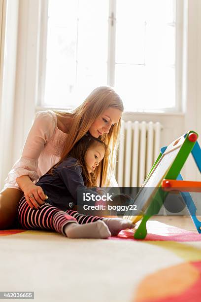 Mother And Daughter Drawing In The Room Stock Photo - Download Image Now - 20-29 Years, Activity, Adult