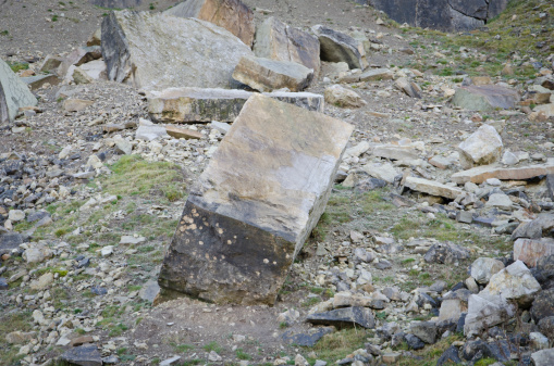 Limestone boulder embedded in a scree slope