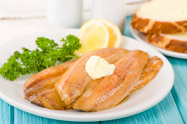 Smoked Kippers Smoked Kippers - Butterfly smoked herring served with bread. kipper stock pictures, royalty-free photos & images