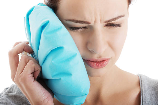 istock Young woman with toothache and ice bag. 462039415