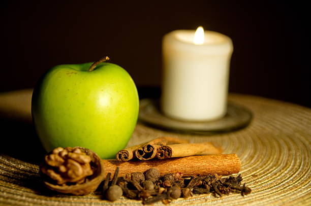 istock Green apple, cinnamon, walnut and a candle 462039713