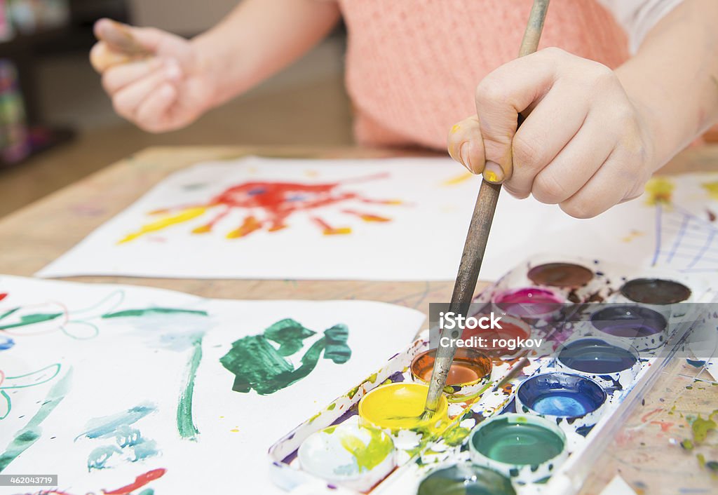 drawing by paints the child dips a finger in paint what to draw Child's Drawing Stock Photo