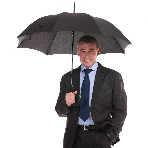 istock business man stands under umbrella 462051067