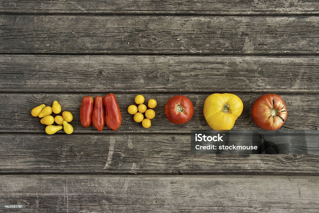 Tomato collection from the garden Colorful tomato breeds on a wooden board Fashion Stock Photo