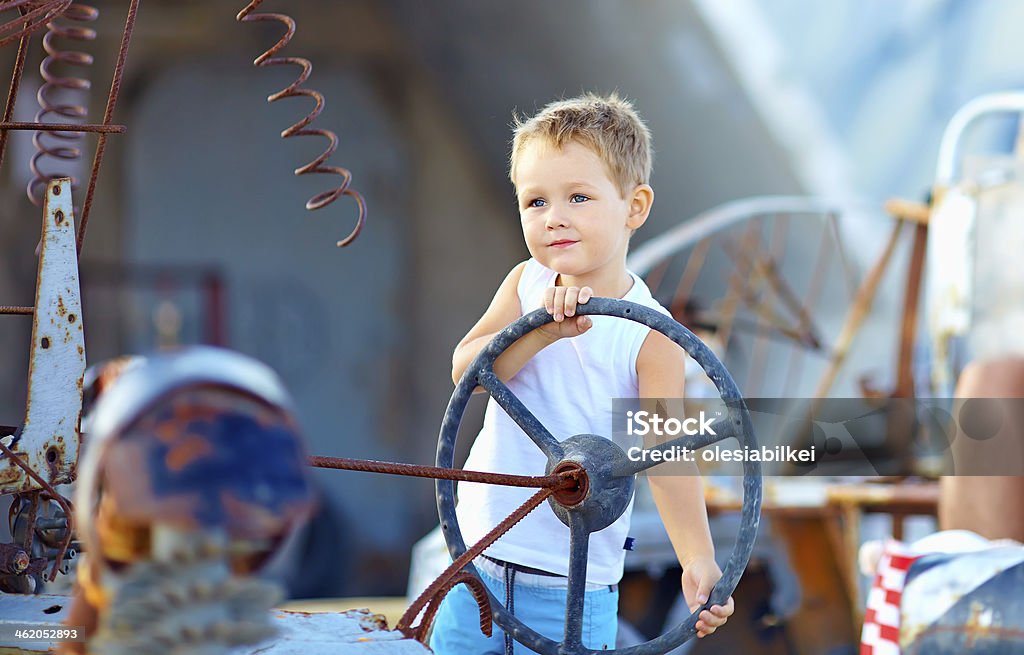 cute child boy pretends driving an imaginary car Child Stock Photo