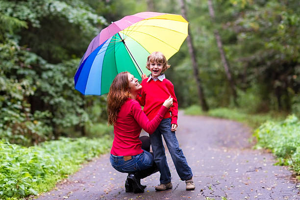 istock Mother and her son under a umbrella 462054897