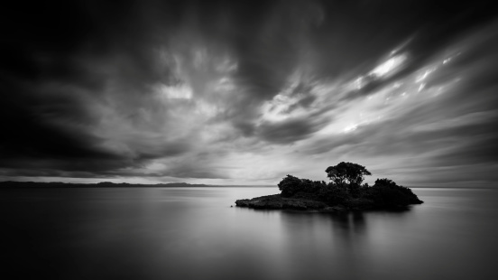 Black and white photo of a lonely Caribbean island under a dramatic sky, in Cayo Levantado, Dominican Republic.