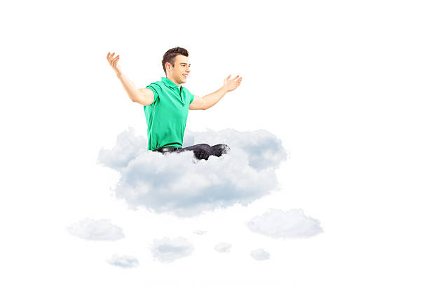 istock Happy male sitting on a cloud and spreading his arms 462064027