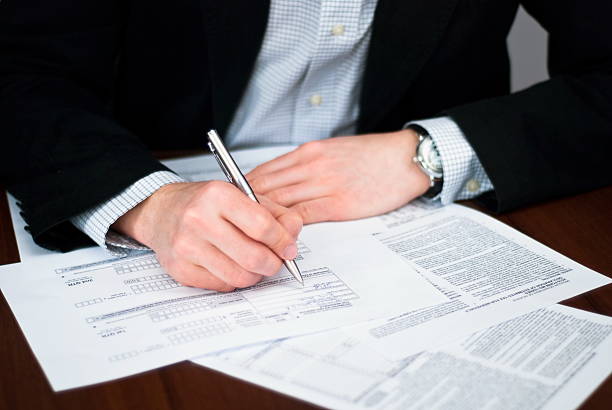 istock Business men filling out some documents on a desk. 462067873