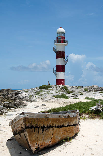 istock Boat and lighthouse  at Punta Cancun 462068339