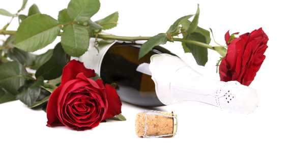 Red rose and a bottle of champagne. Isolated on a white background.