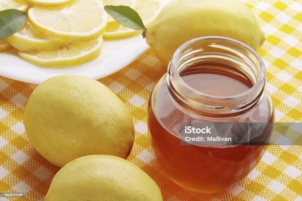 fragrant honey Fresh fragrant honey in a glass jar with lemon Alternative Therapy Stock Photo