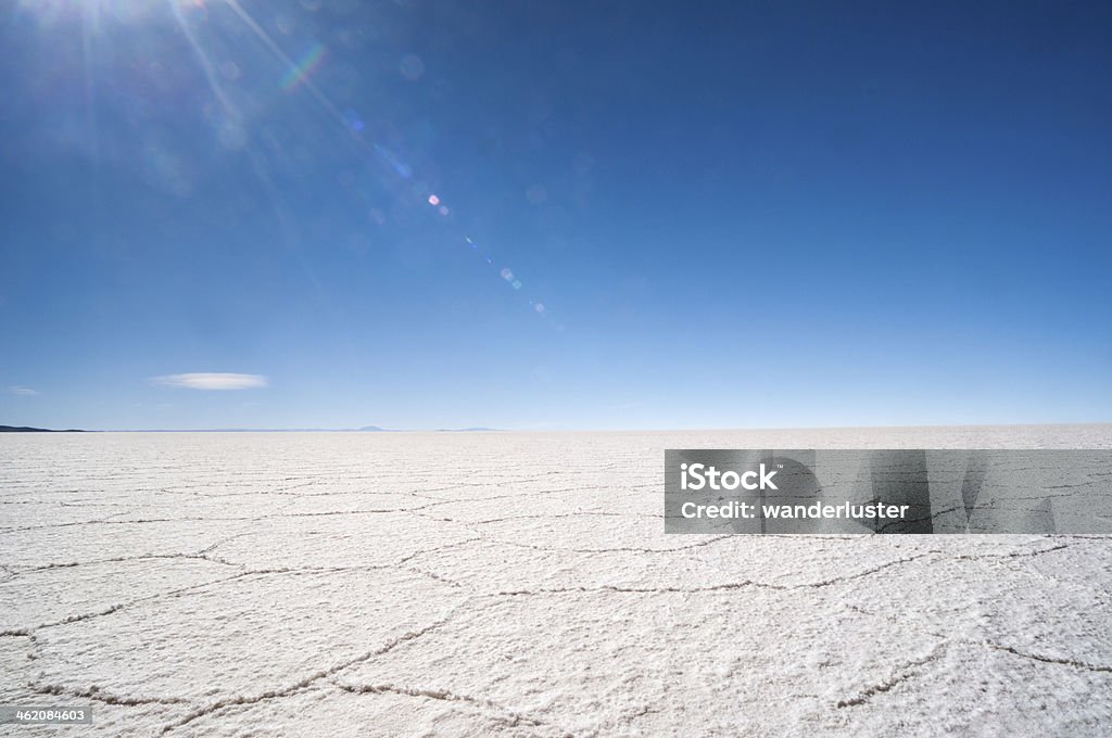 Bolivian salt flats during dry season Hexagonal shaped salt flats, polygonal lines of raised salt created from evaporation in dry season,  Salar de Uyuni, Bolivia, South America. Underneath this salt crust is the world's largest reservoir of lithium, an essential element of batteries. January 2013 marked the first major attempt to extract lithium in Bolivia. Salar de Uyuni covers an area of 6,510 square miles and sits at an elevated altitude of 3500 meters. Bolivia Stock Photo