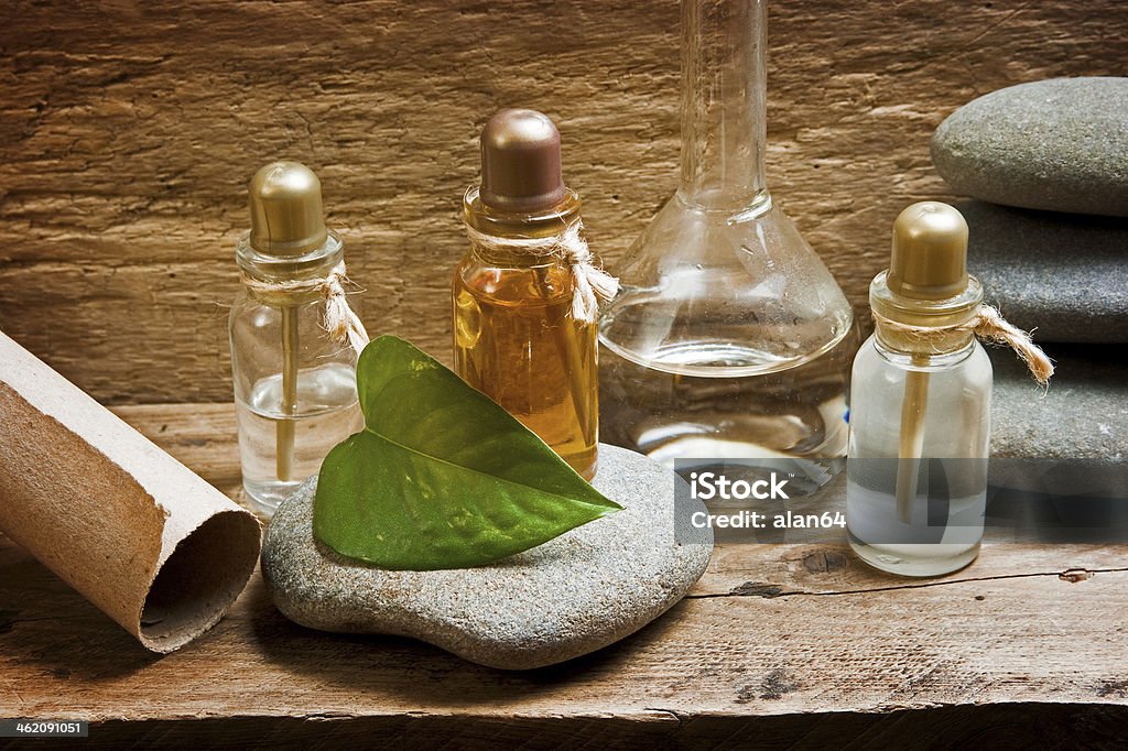 Vials with essential oils Vials with essential oils against the old wooden walls Aromatherapy Stock Photo