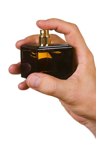 istock bottle of cologne in his hand 462096335