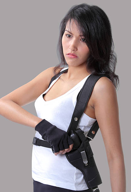 asian woman wearing white vest and holding a gun on her hand