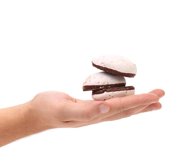 istock White Kiss Cookies with chocolate in hand. 462101755