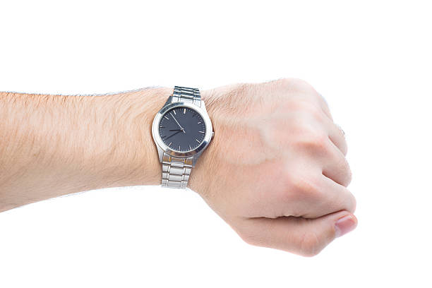 istock Hand wearing a silver and black watch over white background 462104921