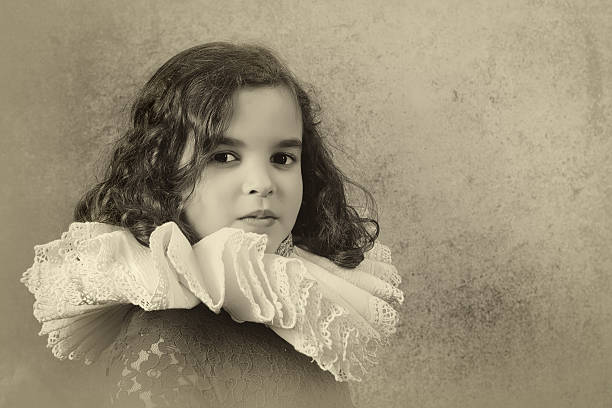 Sweet victorian girl posing in the old style with a ruff collar