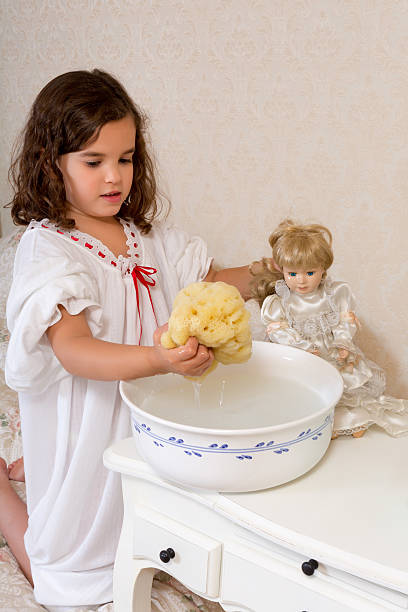 istock Vintage girl washing doll 462117417