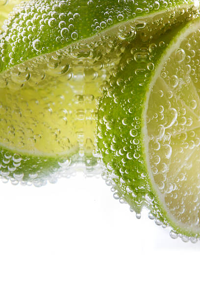 istock Bubbles of mineral water and sliced lime 462117867