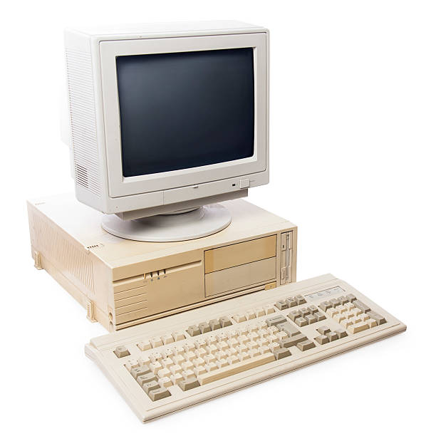 istock Very old desktop computer, keyboard & monitor on plain white 462119649