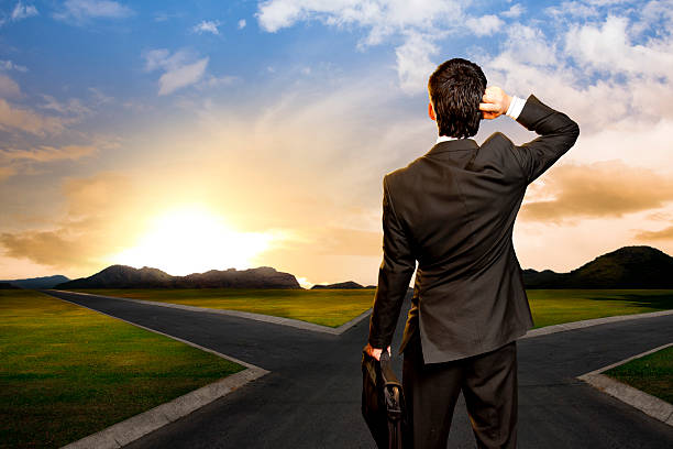 istock young businessman in front of a crossroad 462120701