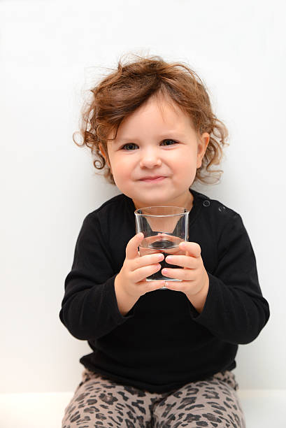 istock Sweet baby girl drinking water 462127727