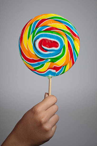 istock Hand holding colorful lollipop candy 462131999