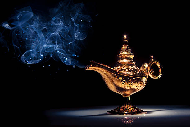 istock A gold genie lamp with smoke on black background 462136635