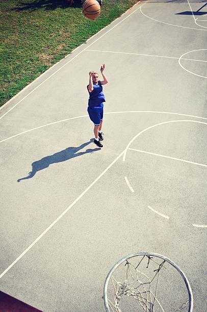 istock Basketball player jumping and shooting the ball 462137181