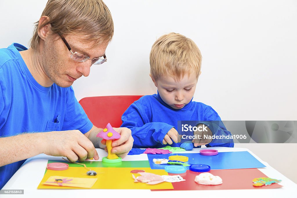 father and son playing with clay father and son playing with clay, early learning and daycare concept Activity Stock Photo