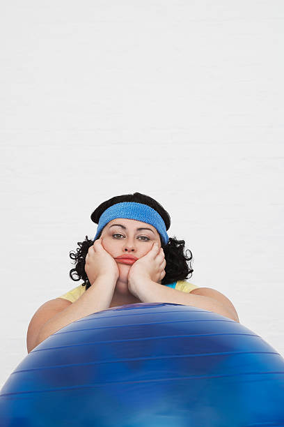 istock Overweight Woman Sitting Behind Exercise Ball 462162783