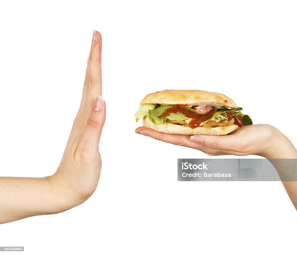 Say No to Unhealthy Food! Female hand rejecting the offered unhealthy junk food. Burger Stock Photo