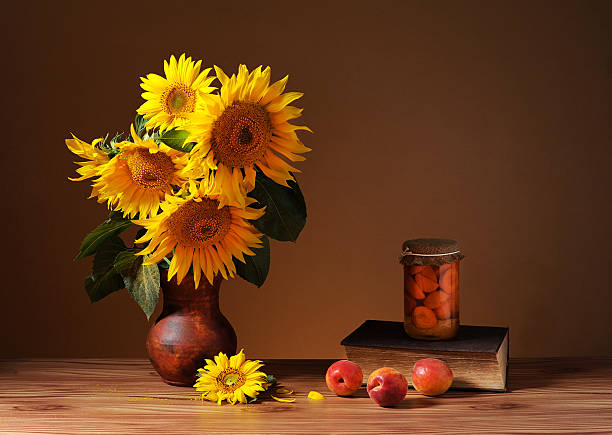 Sunflowers in a ceramic vase and books on the table
