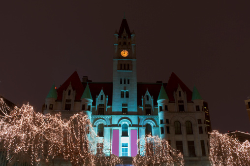 Architecture of historic building surrounding Rice Park in Saint Paul and holiday lights at night