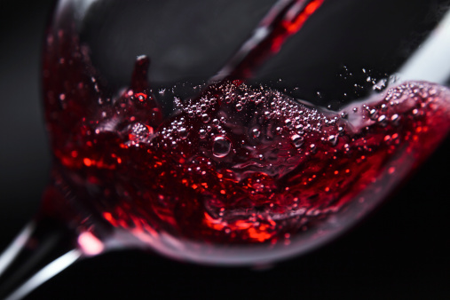 Red wine in wineglass on  black background