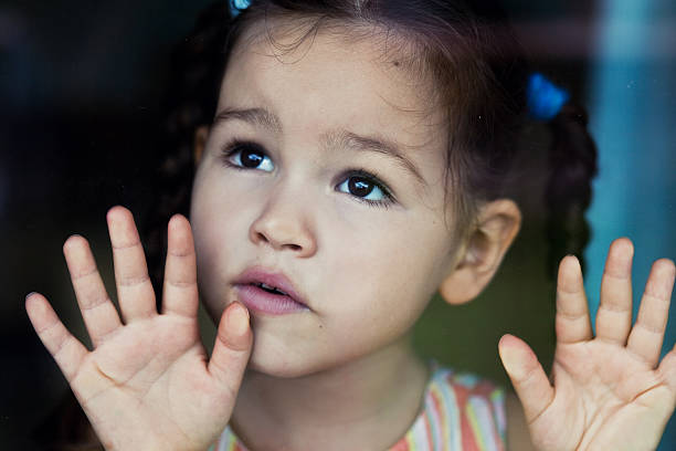 Girl waiting by the window stock photo