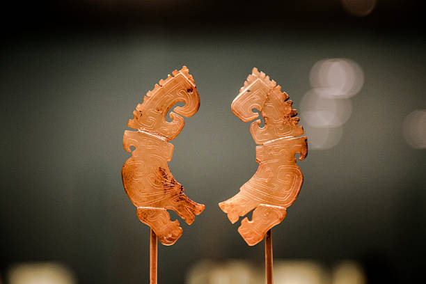 Jade Extremely valuable Chinese ancient decoration jade, carved with phoenix,displayed in a museum. This jade was decoration of aristocracy of Shang Dynasty, 1600 to 1050 B.C. phoenix stone stock pictures, royalty-free photos & images