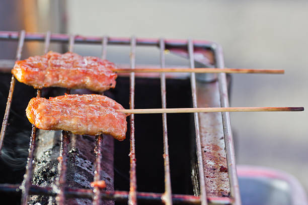 istock Roasted porks sticks grill on electrical roaster. 462197875