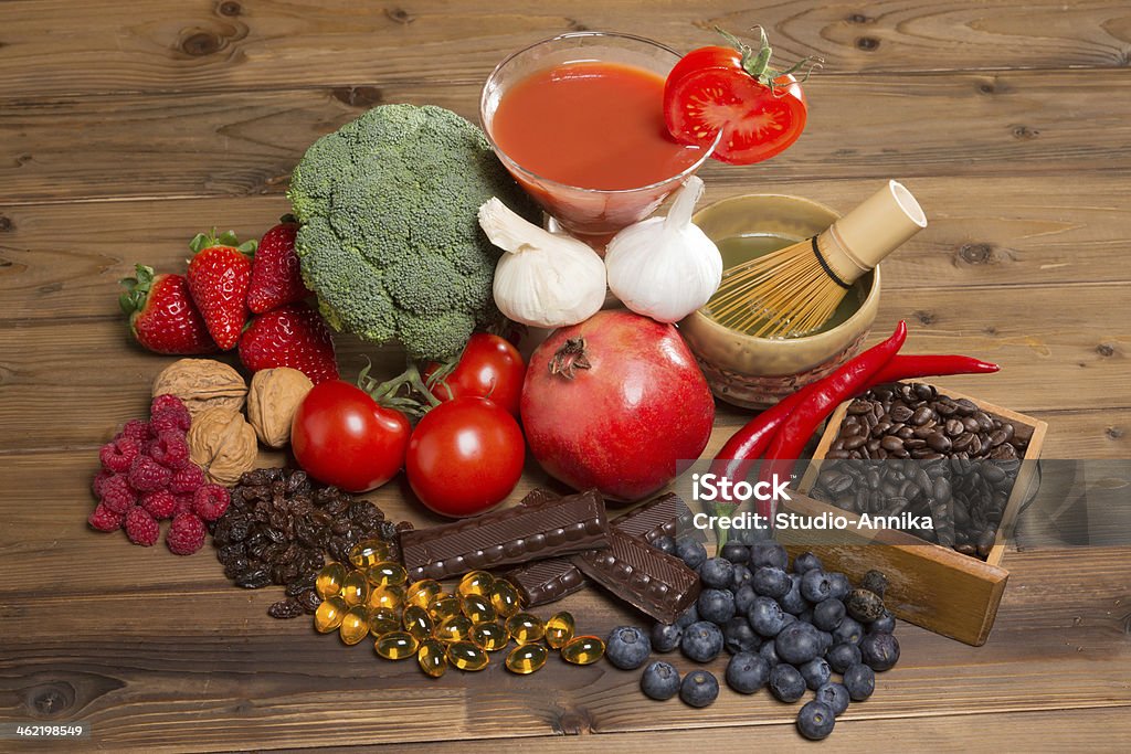 Antioxidants for good health Healthy antioxidants fruits and vegetables on a wooden table Antioxidant Stock Photo