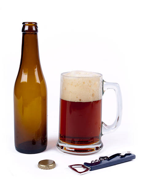 Empty bottle of bock beer next to a full glass stock photo