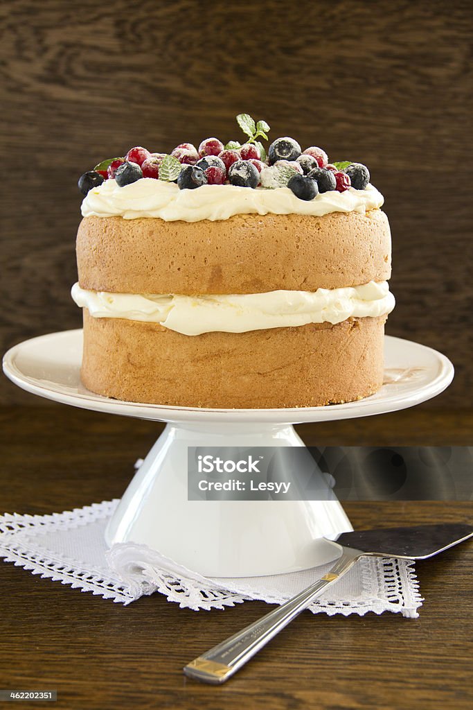 Sponge cake with whipped cream and fresh berries. Baked Pastry Item Stock Photo