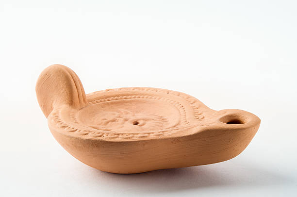 Little Crimean Oil Lamp A little Ukrainian oil lamp made in clay, from the town of Chersonesus in Crimea clay oil lamp stock pictures, royalty-free photos & images