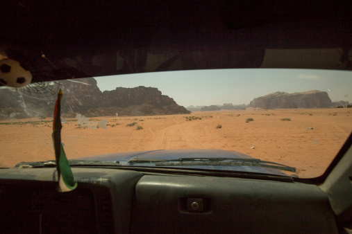 Picture of car driving throu Wadi Rum desert