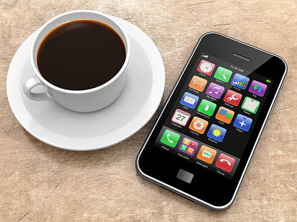 istock Smartphone and cup of coffee on wooden table 462204417
