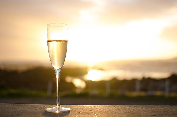 Two champagne flutes together in front of a hot tub