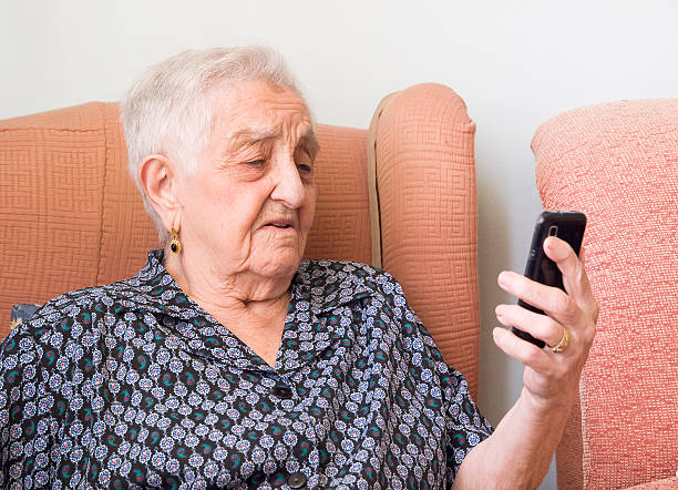 istock Elderly woman looking at a smartphone with confused expression 462205289